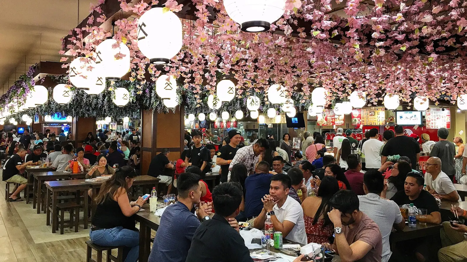 提灯と桜の飾りの下に並ぶ白木屋フードコートの客席